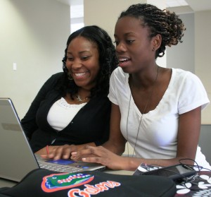 Female students emailing on laptop