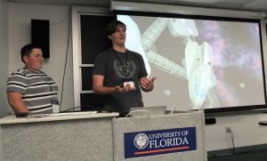PHOTO: Photo of two male high school students presenting at the June 16, 2017 Gator Computing Program symposium.