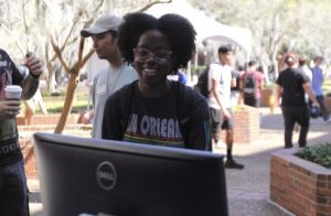 PHOTO: Female student learning at the AI in education table, during the 2023 Tech Fair. University of Florida.