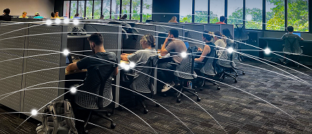 GRAPHIC: Students studying in carrels in Marston Science Library. Wi-Fi access point graphics overlay the image. University of Florida.