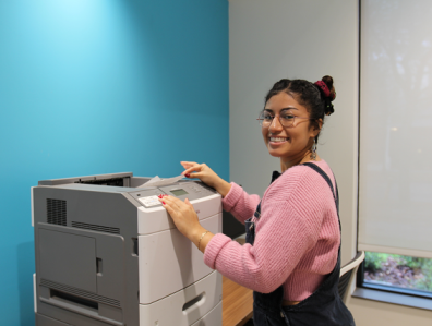 PHOTO: Student using a UFIT print station in a campus lab. University of Florida.