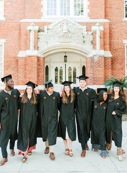 PHOTO: Group of students in graduation cap and gown on the University of Florida campus.