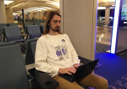 PHOTO: Student using VPN with laptop while sitting in Orlando Int'l Airport. University of Florida.